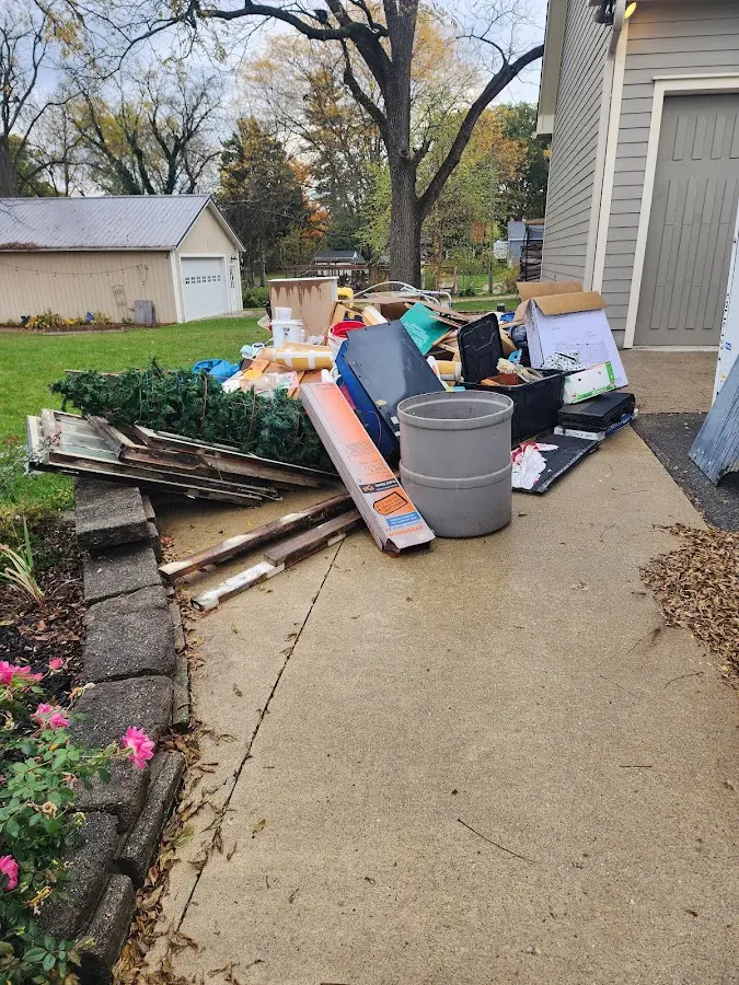 Dumpster being loaded with debris for 12 Yard Dumpster Rental in Agawam Town